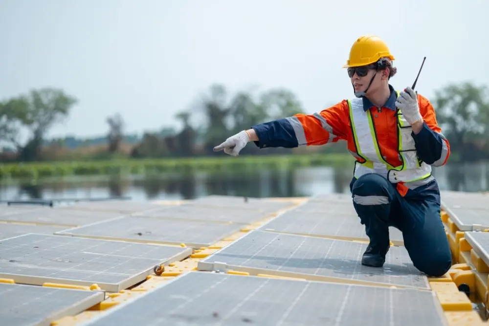 Maintenance technician inspecting solar panels during property maintenance and facility management operations