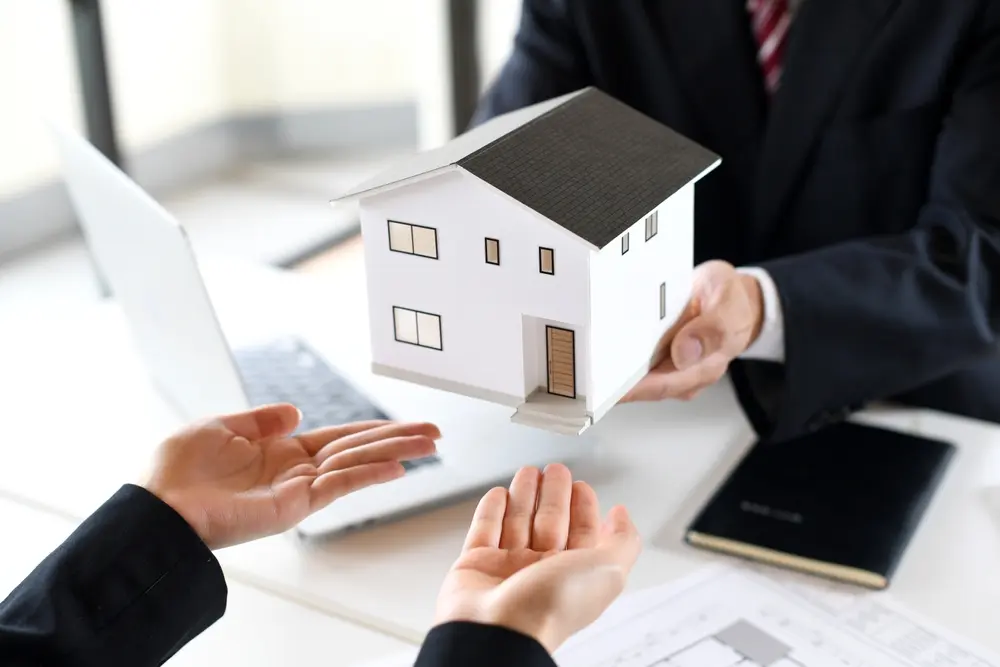 Property management professional presenting model home during homeowner association consultation